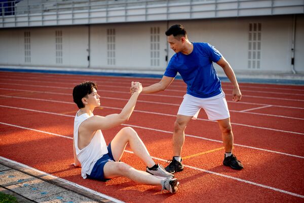 Asian,Man,Is,Grabbing,Or,Pulling,His,Friend,Hand,Helping